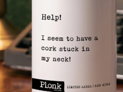 A Wine bottle with a cork stuck in the neck