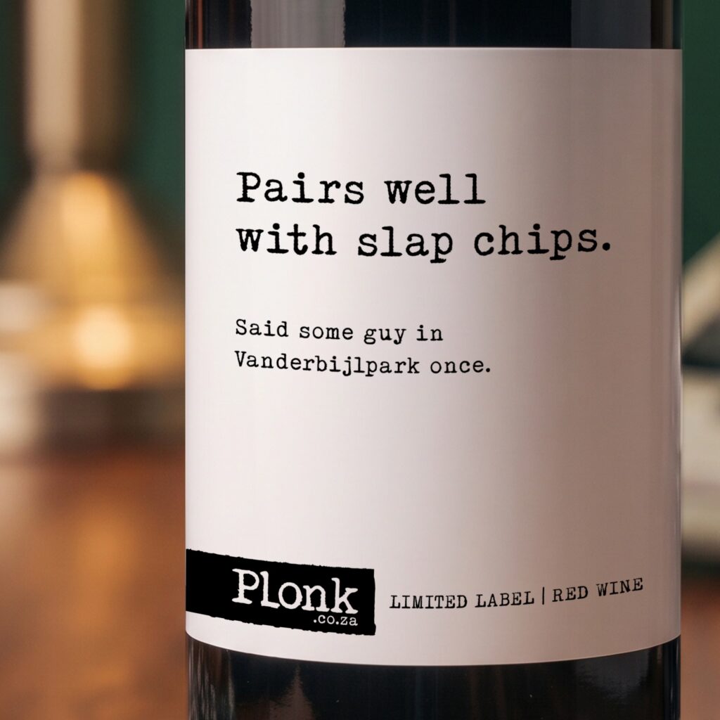 Bottle of Plonk wine showing the pairs well with slap chips label