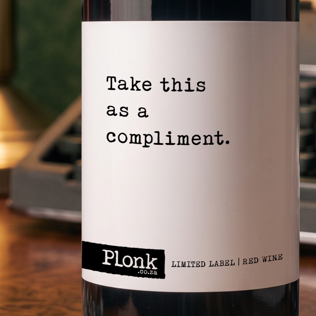 Bottle of Plonk wine showing the take this as a compliment label