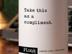 Bottle of Plonk wine showing the take this as a compliment label